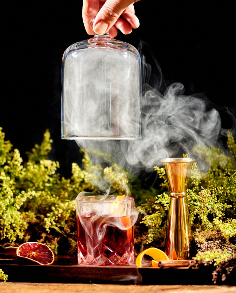 Smoke wafting off of a negroni