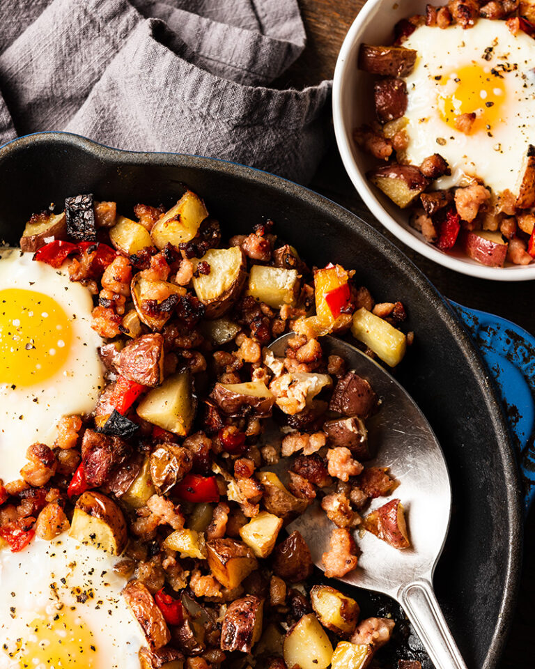 Skillet of breakfast hash next to a smaller bowl of hash